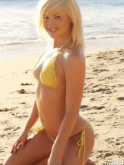 Stunning Alluring Vixen blonde Ashlee Madison shows off at the beach in a skimpy string bikini