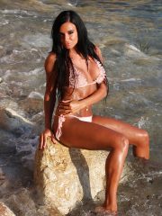 Big titted pornstar babe Ashley Bulgari strips off bikini on the beach